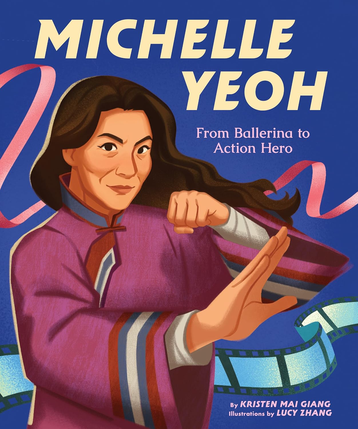 A nonfiction picture book cover depicting Michelle Yeoh looking warm but fierce as she strikes a martial arts pose against a dark blue background decorated with a pink ballet ribbon and blue movie film